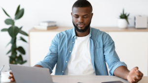 man meditating at desk